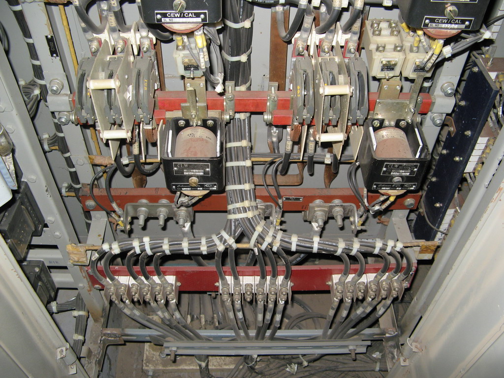 View of three-phase busbar cubicle and contactors for auxiliary machines complete with interlocking contact block assemblies.