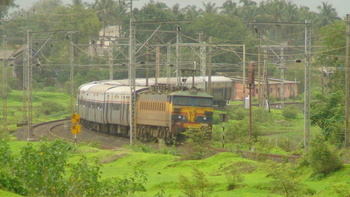 11 coach Mumbai Pune Pragati Express with a KYN WCAM3 21889 taking a turn at Neral outer & proceeding towards Bhivpuri Road.