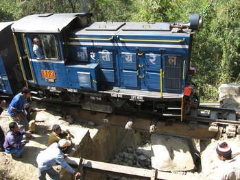 The NJP-Darjeeling toy train loco slowly traverses a partially collapsed bridge in the Sukna-Kurseong section. One of the suppor