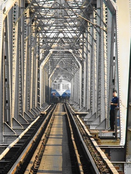 Steel Steel everywhere! 
Stealing the show – A Vasai Road Diva push pull train - passes through Ulhas Bridge. 
 (Arzan Kotval)