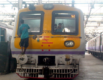 Workers cleaning the glass from outside and inside of Mrvc Emu at Bct Emu Car Shed. Its hardwork and dedication of these staff t