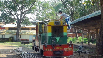 WHAT’S ON THE TOP ?

A railway worker is actively inspecting the narrow guage engine at Matheran station before commencement o