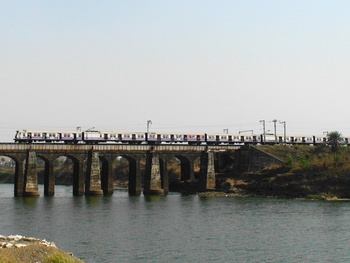 A MRVC Emu makes it's way towards Asangaon by passing through a river bed just after Titvala station. (Arzan Kotval)