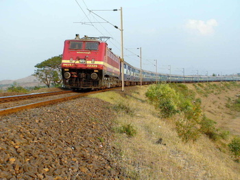 The legendary 2860 Howrah Mumbai Cst Gitanjali Express passes through a sharp curve near Padli station in the fading evening lig