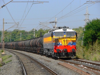 A freshly painted KYN WCAG1# 21973 takes the load of 45 oil tanker wagons with utmost ease at Km71 between Saphale and Vaitarna 