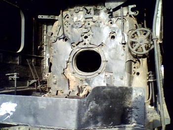 A cab view of YG-4129. Controls are removed from the cab. You can see the firebox in middle and direction wheel control at left 